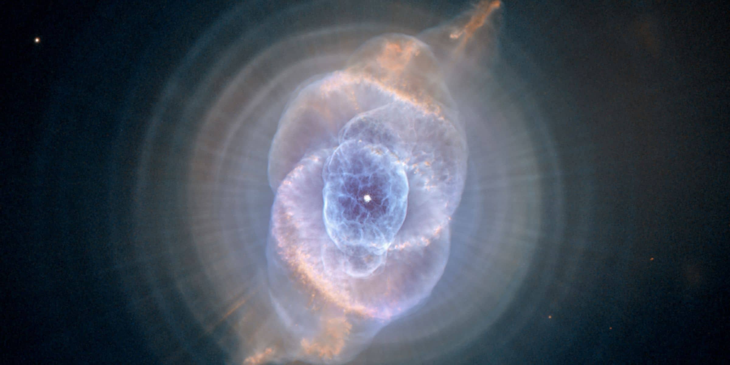  Three thousand light-years away, the Cat's Eye Nebula, a dying star throws off shells of glowing gas